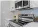 Well-equipped kitchen with stainless steel range, microwave, and stylish backsplash at 3408 Brentwood Rd, Raleigh, NC 27604