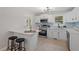 Open kitchen with stainless steel appliances, a marble island, and bright white cabinets, ideal for cooking at 3408 Brentwood Rd, Raleigh, NC 27604