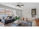 Bright living room with large windows, comfortable seating, and hardwood floors at 3408 Brentwood Rd, Raleigh, NC 27604
