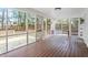 Screened in porch with wooden flooring and lots of windows at 3408 Brentwood Rd, Raleigh, NC 27604