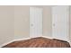 Bright bedroom features two closets, neutral walls, and wood-look flooring at 4000 Volkswalk Pl, Raleigh, NC 27610