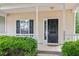 Inviting front porch with classic black door, white trim, and manicured shrubs at 4000 Volkswalk Pl, Raleigh, NC 27610
