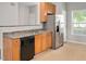 Kitchen with stainless steel refrigerator, breakfast bar, and bright lighting at 4000 Volkswalk Pl, Raleigh, NC 27610