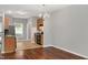Open kitchen and dining area boasts hardwood floors and modern chandelier at 4000 Volkswalk Pl, Raleigh, NC 27610