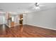 Open-concept living room flows into kitchen, featuring hardwood floors and modern fixtures at 4000 Volkswalk Pl, Raleigh, NC 27610