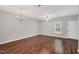 Spacious living room with hardwood floors, ceiling fan, and natural light at 4000 Volkswalk Pl, Raleigh, NC 27610
