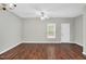 Bright living room featuring hardwood floors, a ceiling fan, and a door leading outside at 4000 Volkswalk Pl, Raleigh, NC 27610