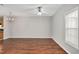 Large living room with hardwood floors, ceiling fan, and ample natural light at 4000 Volkswalk Pl, Raleigh, NC 27610