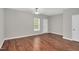 Open living room with hardwood floors, a ceiling fan, and natural light at 4000 Volkswalk Pl, Raleigh, NC 27610