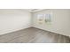 Bright, empty bedroom with wood floors and natural light at 441 White Birch Ln # 66, Angier, NC 27501