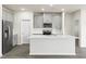 Modern kitchen with gray cabinets, stainless steel appliances, and a large island with quartz countertops at 441 White Birch Ln # 66, Angier, NC 27501
