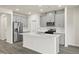Modern kitchen featuring gray cabinets, stainless steel appliances, and a large island at 441 White Birch Ln # 66, Angier, NC 27501