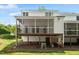 Back exterior of home with a screened-in deck and a spacious, green lawn at 4540 Mistiflower Dr, Raleigh, NC 27606