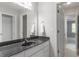 Well-lit bathroom featuring a single sink, large mirror, and linen closet at 4540 Mistiflower Dr, Raleigh, NC 27606