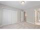 Carpeted bedroom with closets, open doors and neutral paint color at 4540 Mistiflower Dr, Raleigh, NC 27606