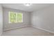 A neutral bedroom with a window providing natural light and a clean, simple design at 4540 Mistiflower Dr, Raleigh, NC 27606