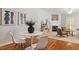 Dining area with views of the fireplace, hardwood floors, modern furniture, and art at 4540 Mistiflower Dr, Raleigh, NC 27606