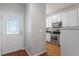 Welcoming entryway with hardwood floors, decorative glass front door, leading to the kitchen with stainless steel appliances at 4540 Mistiflower Dr, Raleigh, NC 27606
