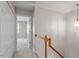 Upstairs hallway with a view into a bedroom and stairs to the lower level at 4540 Mistiflower Dr, Raleigh, NC 27606