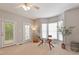 Bright home office with a glass desk, bay windows, and a door to the outside at 4540 Mistiflower Dr, Raleigh, NC 27606