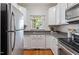 Kitchen with stainless appliances, granite countertops, and white cabinets. Offers a bright and modern feel at 4540 Mistiflower Dr, Raleigh, NC 27606