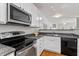 Stylish kitchen featuring stainless steel appliances, dark countertops and a view overlooking a cozy dining area at 4540 Mistiflower Dr, Raleigh, NC 27606