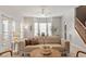 Cozy living room with a ceiling fan, bay window, and stairs to the next level at 4540 Mistiflower Dr, Raleigh, NC 27606