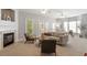 Bright living room featuring a fireplace, neutral tones, and comfortable seating for relaxation and entertaining at 4540 Mistiflower Dr, Raleigh, NC 27606