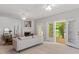 Bright living room with fireplace, ceiling fan, and sliding glass doors to the outdoor deck at 4540 Mistiflower Dr, Raleigh, NC 27606