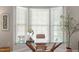 Dedicated office area with a modern glass desk and bright natural light from bay windows at 4540 Mistiflower Dr, Raleigh, NC 27606