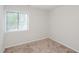 Bright bedroom features a large window and neutral carpet, creating a cozy space at 4602 Millstone Dr # C, Raleigh, NC 27604