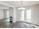 Dining room features modern floors, a chandelier, and French doors to backyard at 4602 Millstone Dr # C, Raleigh, NC 27604