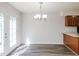 Bright dining area boasts modern floors and a chandelier, located off kitchen at 4602 Millstone Dr # C, Raleigh, NC 27604