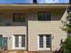 Exterior view of home featuring double French doors, windows and siding at 4602 Millstone Dr # C, Raleigh, NC 27604