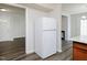 View of the kitchen with white refrigerator and sightline into other rooms at 4602 Millstone Dr # C, Raleigh, NC 27604