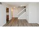 Open floor plan features new floors, entry door, staircase and adjacent half bathroom and kitchen at 4602 Millstone Dr # C, Raleigh, NC 27604