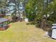 Expansive backyard featuring mature trees, and a storage shed, offering endless possibilities for outdoor enjoyment at 4908 Vallery Pl, Raleigh, NC 27604