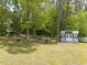 The spacious backyard features mature trees, a storage shed, and plenty of room for recreation at 4908 Vallery Pl, Raleigh, NC 27604