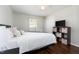 Bedroom featuring wood floors, storage unit, and a closet with bi-fold doors at 4908 Vallery Pl, Raleigh, NC 27604