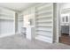 Large walk-in closet featuring custom shelving, vanity, and hardwood flooring at 4908 Vallery Pl, Raleigh, NC 27604