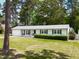 A single story house with garage, mature trees, and dark shutters at 4908 Vallery Pl, Raleigh, NC 27604