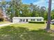 Charming one-story home with a well-manicured lawn, attached garage, and mature trees at 4908 Vallery Pl, Raleigh, NC 27604