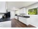 Kitchen showcasing white cabinets, stainless steel appliances, and wood floors at 4908 Vallery Pl, Raleigh, NC 27604