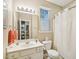 Well-lit bathroom featuring a white vanity and toilet plus a window offering natural light at 5026 Celtic Ct, Raleigh, NC 27612