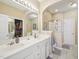 Primary bathroom with double sink vanity, walk-in closet and glass shower featuring great natural light at 5026 Celtic Ct, Raleigh, NC 27612