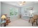 Bedroom with a built-in desk, a rocking chair, and a window overlooking the backyard at 5026 Celtic Ct, Raleigh, NC 27612
