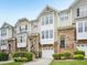 Charming townhouse with a stone facade, inviting entrance, and attached garage at 5026 Celtic Ct, Raleigh, NC 27612