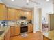 Well-equipped kitchen with granite countertops, stainless steel appliances, and wood cabinets at 5026 Celtic Ct, Raleigh, NC 27612