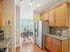 Bright kitchen featuring stainless steel refrigerator and granite countertops with adjacent eat in kitchen at 5026 Celtic Ct, Raleigh, NC 27612