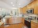 Modern kitchen featuring stainless appliances, granite countertops, and wood cabinetry at 5026 Celtic Ct, Raleigh, NC 27612